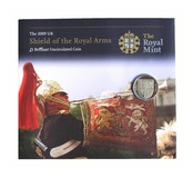 2009 £1 Brilliant Uncirculated coin Rev: 'Royal Arms' enclosed within a Royal Mint descriptive Folder, with an heavy crease  aUNC